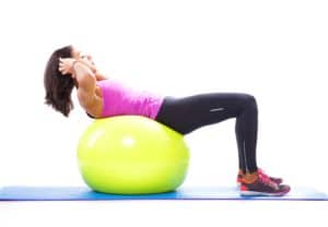 Woman doing abdominals with a fitness ball